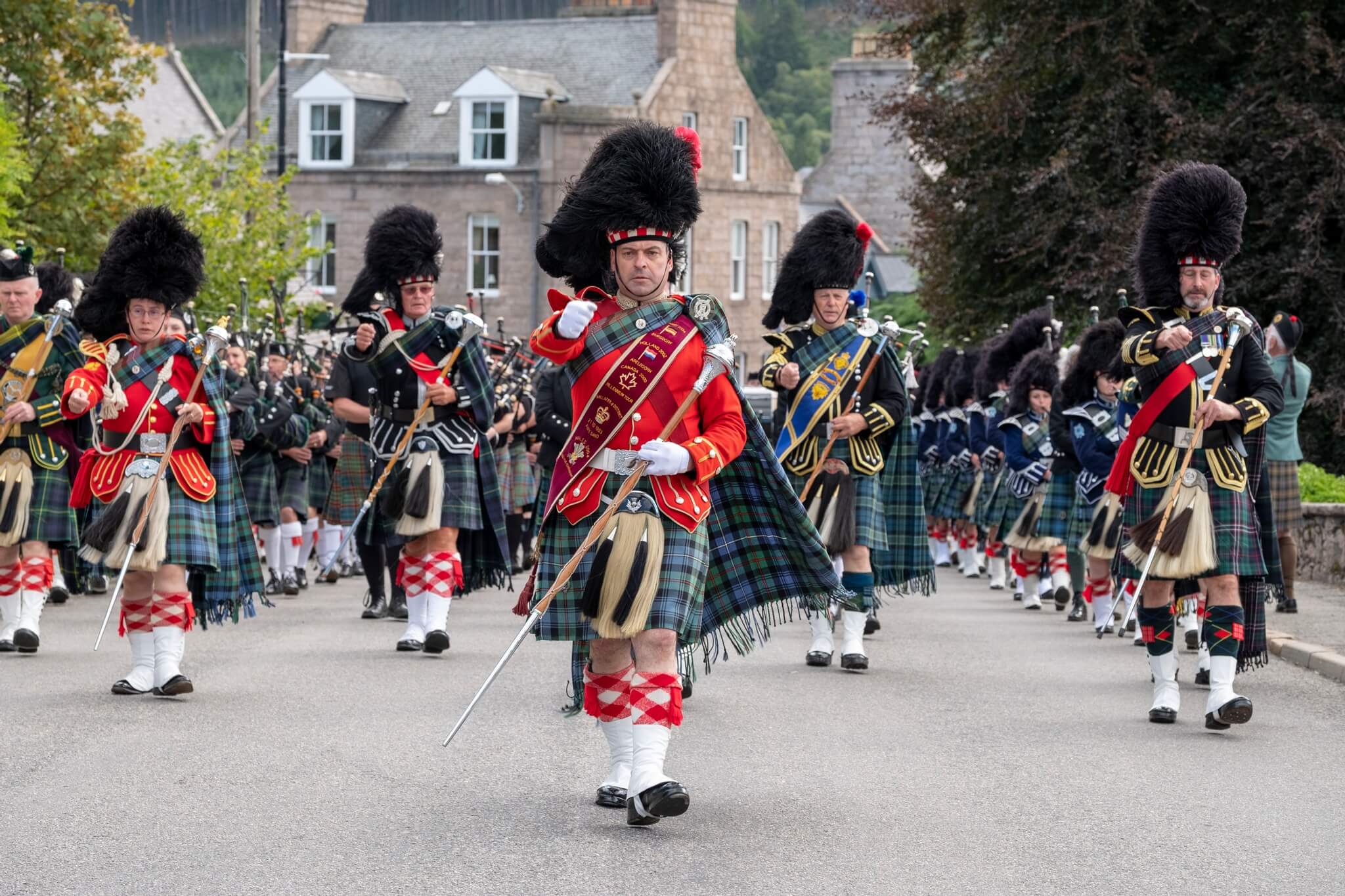 Pipe band marching at Ballater Highland Games