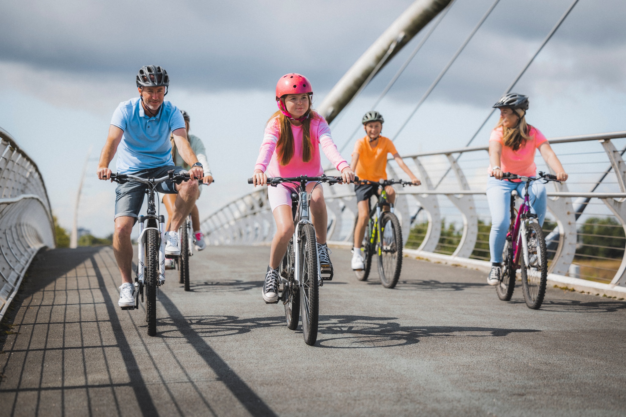 A family cycle across the Dalmarnock Smart Bridge which connects Rutherglen with Dalmarnock.