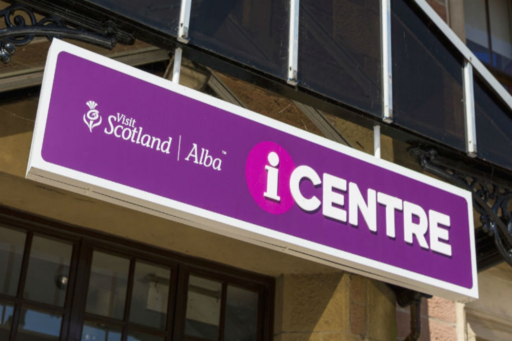 Purple VisitScotland iCentre sign with VisitScotland/Alba branding.